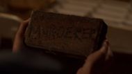 Brick thrown into the Miller residence (Screenshot from Ginny & Georgia: Season 3 Official Trailer/Netflix on YouTube)